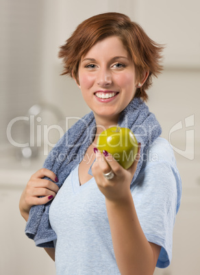 Pretty Red Haired Woman with Towel Holding Green Apple