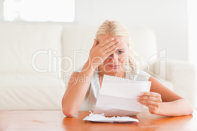 Despaired woman holding a letter
