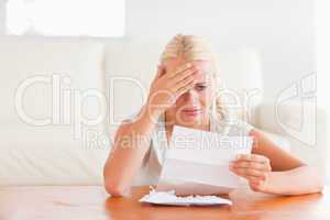 Despaired woman holding a letter