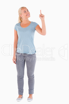 Smiling woman pointing at copyspace