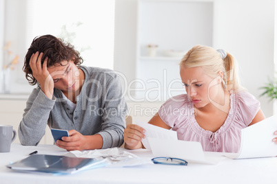 Couple in despair while doing accounts