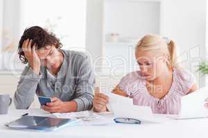 Couple in despair while doing accounts