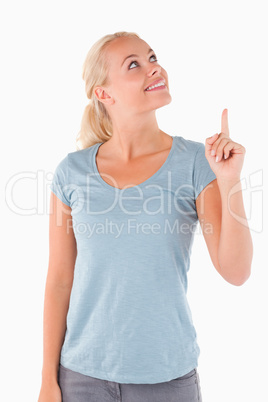 Smiling cute woman pointing at copyspace