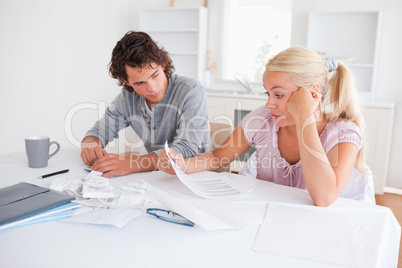 Stressed couple doing accounts