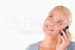 Smiling blond woman on the phone