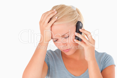 Sad blond woman on a phone