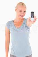 Smiling gorgeous woman showing a phone