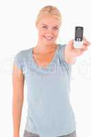 Smiling cute woman showing a phone