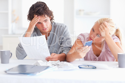 Unhappy couple doing accounts