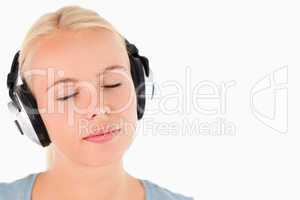 Portrait of a woman with headphones having eyes closed