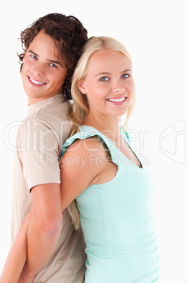 Close up of a Happy couple standing back to back