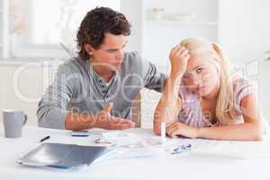 Despaired couple doing their accounts
