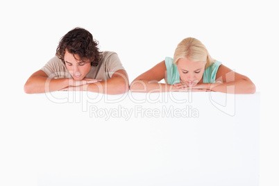 Couple leaning on a whiteboard