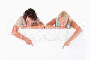 Man and woman pointing on a whiteboard