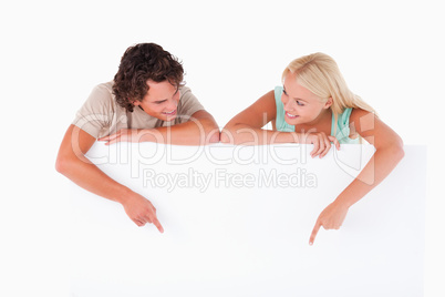 Handsome Man and woman pointing on a whiteboard