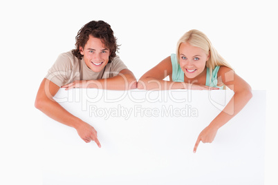 Man and cute woman pointing on a whiteboard