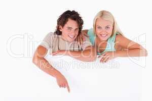 Handsome Man pointing on a whiteboard with woman