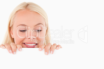 Woman peeking over a whiteboard