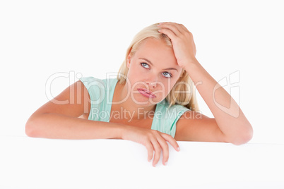 Close up of a sad woman standing behind a whiteboard