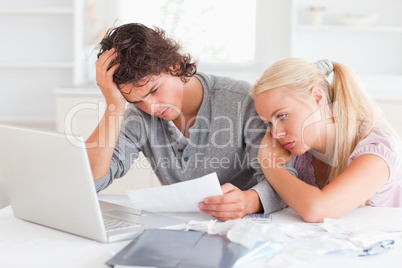 Tired couple doing their accounts