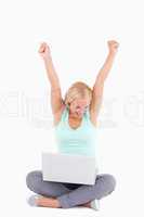 Joyful blond woman with a laptop