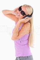 Cute woman with earphones and sunglasses