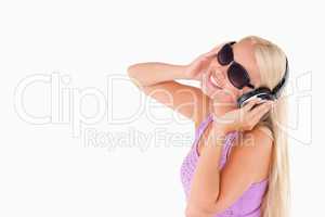 Charming woman with earphones and sunglasses