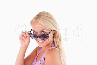 Blond lady peeking over her sunglasses