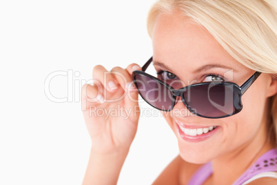 Cute lady peeking over her sunglasses