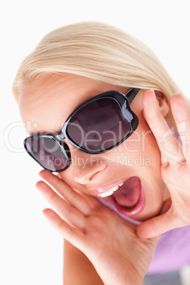 Blond lady with sunglasses in high spirits