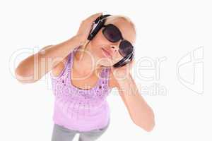 Cheerful lady with sunglasses and earphones