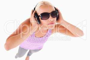 Cheerful woman with sunglasses and earphones