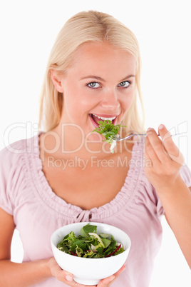 Cute woman eating salad