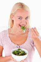 Cute woman eating salad