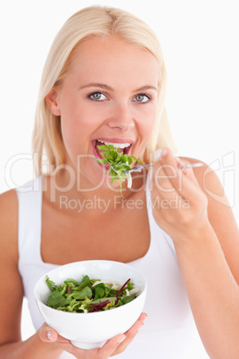 Gorgeous woman eating salad