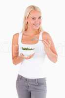Charming lady eating salad