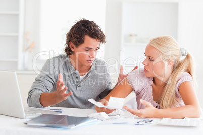 Couple with bills and a laptop