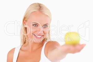 Blond woman holding an apple