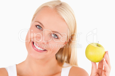 Charming woman holding an apple