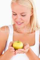 Glorious blond woman holding an apple