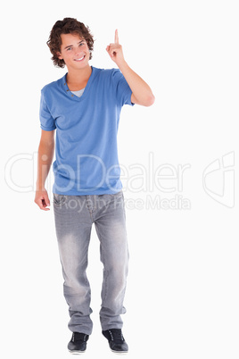 Cute guy pointing at copyspace