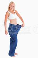 Charming woman wearing jeans that are too big