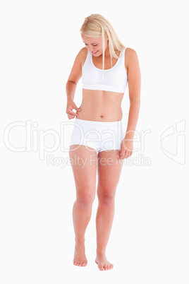 Portrait of a thin woman gripping her waist