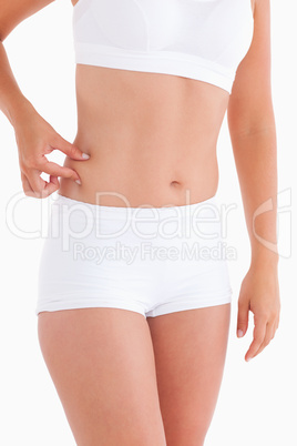 Thin woman gripping her waist