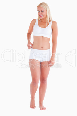 Smiling woman gripping her waist