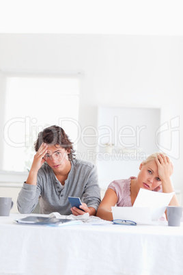 Worn out couple calculating their expenses