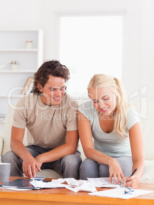 Happy couple calculating their expenses