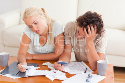 Unhappy couple listing expenses