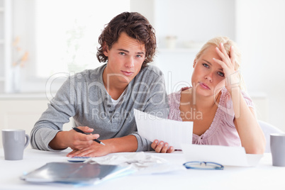 worried couple listing expenses
