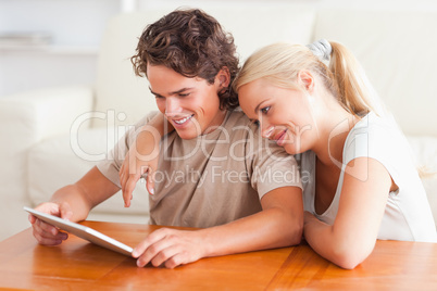 Happy couple with a tablet